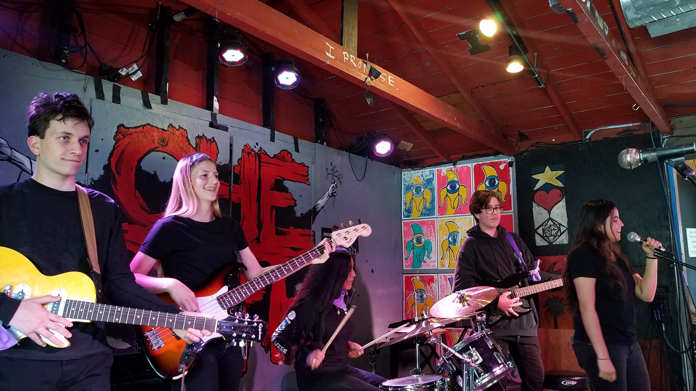 Students in a rock band at Che Cafe