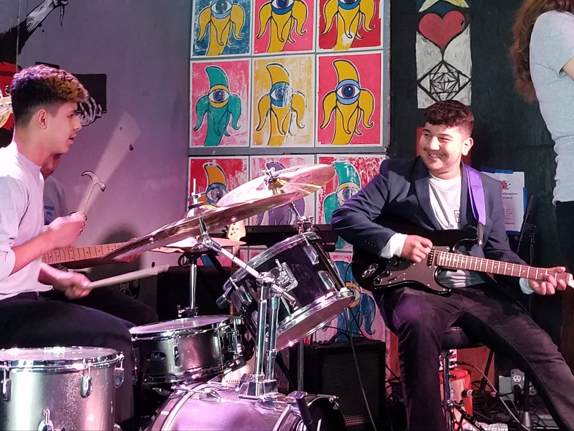 Students in a rock band at Che Cafe